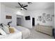 Bright main bedroom featuring a ceiling fan, mounted television, and decorative accents at 341 E Constitution Dr, Gilbert, AZ 85296