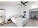 Bright main bedroom featuring plush carpet, neutral decor, and a private door to the outdoors at 341 E Constitution Dr, Gilbert, AZ 85296