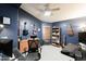 Office with blue walls, ceiling fan, multiple guitars, computers, and a desk at 341 E Constitution Dr, Gilbert, AZ 85296