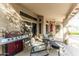 Covered patio with a grill, seating, and fan, creating a perfect space for outdoor entertaining at 341 E Constitution Dr, Gilbert, AZ 85296