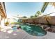 Backyard pool surrounded by palm trees and rocks, offering a private oasis at 341 E Constitution Dr, Gilbert, AZ 85296