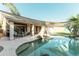 Beautiful pool and backyard area featuring a covered patio, seating, and lush greenery at 341 E Constitution Dr, Gilbert, AZ 85296