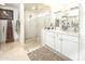 Modern bathroom with double sink vanity, stone countertops, and glass enclosed shower at 4009 S Siesta Ln, Tempe, AZ 85282