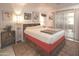 Bright bedroom features a wooden bed frame, contemporary decor, and tiled floor at 4009 S Siesta Ln, Tempe, AZ 85282