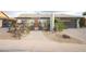 Charming home featuring unique yard decor, brickwork, and a gray garage door at 4009 S Siesta Ln, Tempe, AZ 85282