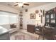 Functional office space featuring a ceiling fan, a desk, and ample storage at 4009 S Siesta Ln, Tempe, AZ 85282