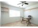 A minimalist office space with adjustable desk, shelves, and tiled floor at 4009 S Siesta Ln, Tempe, AZ 85282