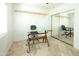 Modern office featuring a glass drafting table, sliding mirror doors, and tile flooring at 4009 S Siesta Ln, Tempe, AZ 85282