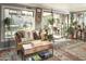 Bright sunroom featuring large windows, comfortable seating, and a serene, plant-filled space at 4009 S Siesta Ln, Tempe, AZ 85282
