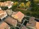 An aerial view of clustered houses with red roofs, surrounded by green trees and bushes at 4313 E Jasper Dr, Gilbert, AZ 85296