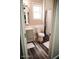 Well-lit bathroom features a white sink and vanity, toilet, window, and shower with curtains at 4313 E Jasper Dr, Gilbert, AZ 85296