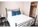 This bedroom features an ornate metal bed frame, closet, and small side table with a lamp at 4313 E Jasper Dr, Gilbert, AZ 85296