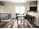 Open-concept living space with sleek black furniture, bar-style seating, and natural light at 4313 E Jasper Dr, Gilbert, AZ 85296