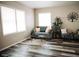 Bright living room with large windows, comfortable seating, and decorative tree art piece at 4313 E Jasper Dr, Gilbert, AZ 85296