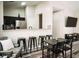 Open-concept dining and living space with kitchen bar and sleek black furniture at 4313 E Jasper Dr, Gilbert, AZ 85296