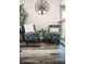Cozy living room sitting area with decorative tree art piece, stylish chairs, and wood-look flooring at 4313 E Jasper Dr, Gilbert, AZ 85296
