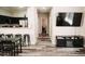 Open-concept living space with kitchen bar and sleek black furniture and decor at 4313 E Jasper Dr, Gilbert, AZ 85296