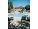 Inviting community pool area with lounge chairs and clear blue water on a sunny day at 4313 E Jasper Dr, Gilbert, AZ 85296