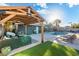 Backyard features a pool, grass, lounge area, and pergola at 4518 W Rose Ln, Glendale, AZ 85301