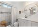 Bright bathroom features a walk-in shower, large round mirror and ample storage at 4518 W Rose Ln, Glendale, AZ 85301