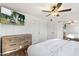 Bright bedroom with a ceiling fan, TV, wood dresser and large mirror at 4518 W Rose Ln, Glendale, AZ 85301