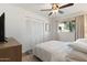 Bright bedroom with a ceiling fan and large closet space for ample storage, creating a serene retreat at 4518 W Rose Ln, Glendale, AZ 85301