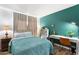 Well-lit bedroom with desk and plant accents, creating a bright and welcoming atmosphere for work or rest at 4518 W Rose Ln, Glendale, AZ 85301