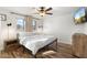 Well-lit bedroom with wood flooring, complemented by large windows that flood the space with natural light at 4518 W Rose Ln, Glendale, AZ 85301
