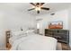 Comfortable bedroom with neutral tones, a large TV, and wood floors, offers a relaxing space at 4518 W Rose Ln, Glendale, AZ 85301