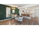 Open floor plan shows stylish dining area next to kitchen with green plant wall and modern mirror at 4518 W Rose Ln, Glendale, AZ 85301