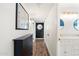 Long hallway with wood floors leads to the bathroom and bedrooms, providing seamless transition through the home at 4518 W Rose Ln, Glendale, AZ 85301