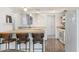 View of bright kitchen with a butcher block island, white countertops, and updated appliances and sink at 4518 W Rose Ln, Glendale, AZ 85301