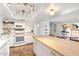 Spacious open kitchen with white appliances, wooden island, and access to the backyard and dining area at 4518 W Rose Ln, Glendale, AZ 85301