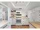 Bright kitchen features white cabinets, marble counters, and appliances in a well-lit space at 4518 W Rose Ln, Glendale, AZ 85301