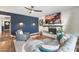 Stylish living room featuring a blue accent wall, fireplace, and comfortable seating at 4518 W Rose Ln, Glendale, AZ 85301
