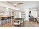 Bright open-concept living area with bar seating, hardwood floors, and modern white kitchen at 4518 W Rose Ln, Glendale, AZ 85301