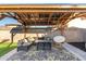 Backyard pergola with lounge seating and table at 4518 W Rose Ln, Glendale, AZ 85301