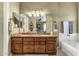 This bathroom features a double vanity, tiled floors, and warm lighting at 4720 E Bighorn Ave, Phoenix, AZ 85044
