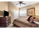 A cozy bedroom features a ceiling fan and shuttered window and warm, neutral colored walls at 4720 E Bighorn Ave, Phoenix, AZ 85044