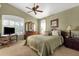 Serene bedroom featuring a ceiling fan, large window, and a traditional-style dresser at 4720 E Bighorn Ave, Phoenix, AZ 85044