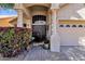 Inviting entryway with double doors, stone columns, lush bougainvillea, and paved walkway at 4720 E Bighorn Ave, Phoenix, AZ 85044
