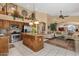 Open-concept kitchen features stainless steel appliances, tile floors, and spacious island with granite countertops at 4720 E Bighorn Ave, Phoenix, AZ 85044