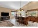 Open kitchen features a center island with bar seating, pendant lighting, and tile flooring at 4720 E Bighorn Ave, Phoenix, AZ 85044