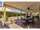 An outdoor living area with a covered patio and an outdoor dining area with a fountain at 4720 E Bighorn Ave, Phoenix, AZ 85044