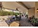 An outdoor living area with a covered patio featuring a dining table and a ceiling fan at 4720 E Bighorn Ave, Phoenix, AZ 85044