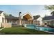 Beautiful backyard featuring a pool with a water feature, a patio, and a well-manicured lawn at 4729 E Arcadia Ln, Phoenix, AZ 85018