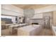 Elegant kitchen with double island, marble countertops, custom cabinetry, and a unique light fixture above island at 4729 E Arcadia Ln, Phoenix, AZ 85018