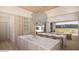 Spacious kitchen featuring a double island, light wood cabinetry, elegant marble countertops, and natural lighting at 4729 E Arcadia Ln, Phoenix, AZ 85018