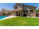 Expansive backyard featuring a covered patio, pool, and ample green space, perfect for entertaining and leisure at 4834 E Robin Ln, Phoenix, AZ 85054