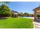 Inviting backyard with well-manicured lawn, refreshing pool, and comfortable outdoor seating area for relaxation at 4834 E Robin Ln, Phoenix, AZ 85054